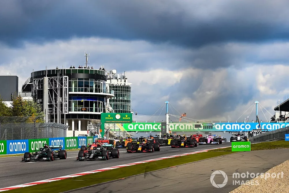 Lewis Hamilton, Mercedes F1 W11, battles with Valtteri Bottas, Mercedes F1 W11, for the lead at the start ahead of the rest of the field