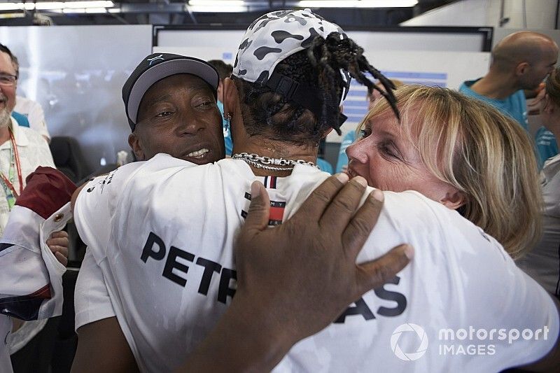 Lewis Hamilton, Mercedes AMG F1, celebrates winning the world championship with his father Anthony and step-mother Linda
