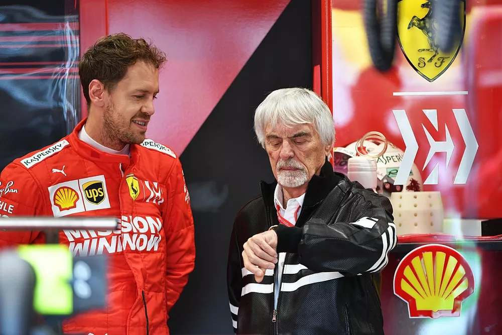 Bernie Ecclestone, Chairman Emiritus of Formula 1, in the Ferrari garage with Sebastian Vettel, Ferrari