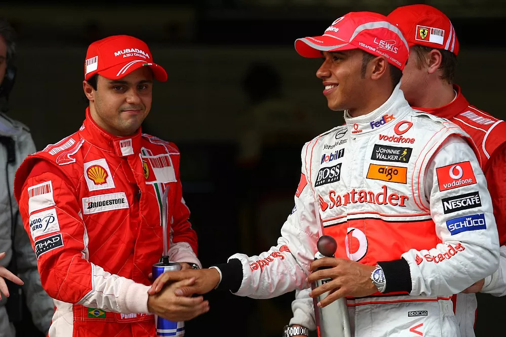 Pole winner Lewis Hamilton celebrates with Felipe Massa