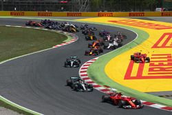 Kimi Raikkonen, Ferrari SF70H and Max Verstappen, Red Bull Racing RB13 collide and crash as Sebastian Vettel, Ferrari SF70H leads at the start of the race