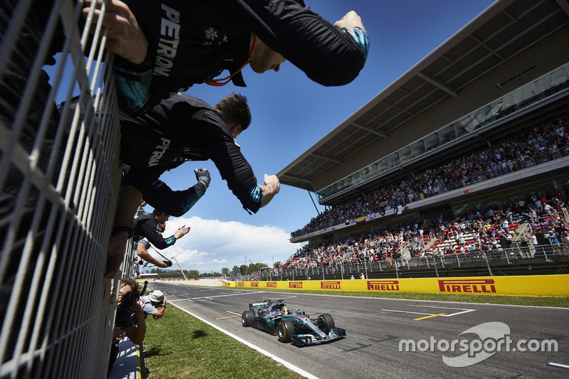 Lewis Hamilton, Mercedes AMG F1 W08, race winner, crosses the line to the delight of his team