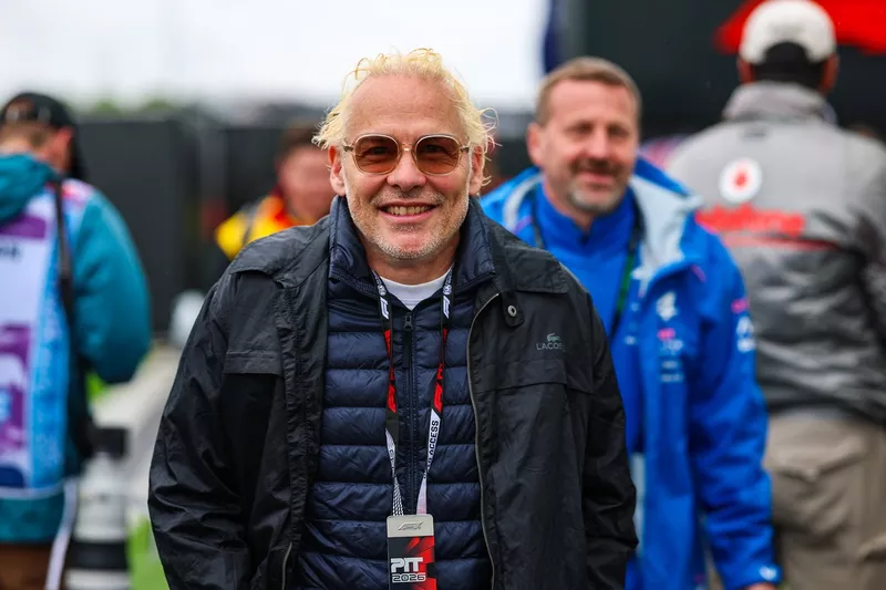 Jacques Villeneuve, ancien pilote de course, se promène dans le paddock.
