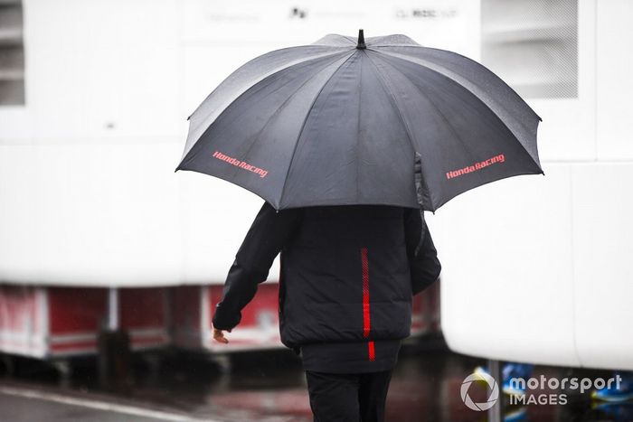 Honda Racing team member with a umbrella