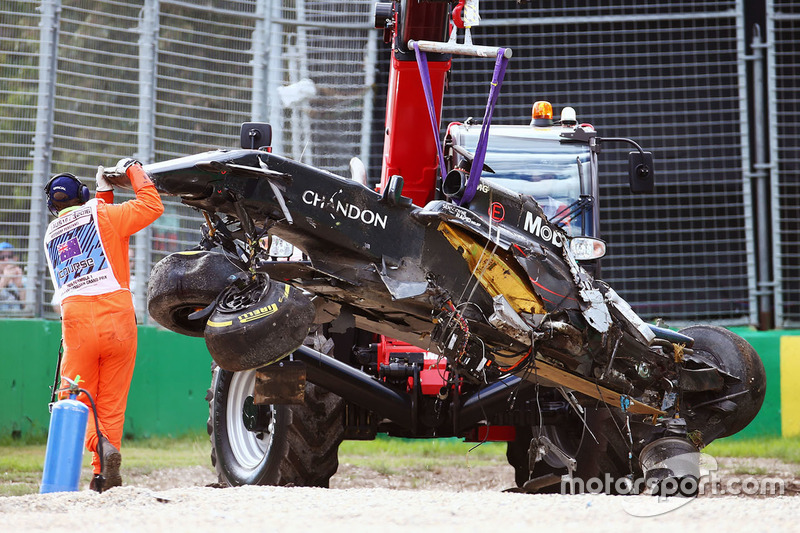 The McLaren MP4-31 of Fernando Alonso, McLaren is removed from the gravel trap after his race stoppi