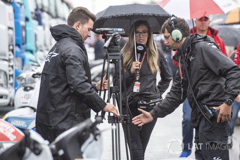 Des journalistes sous la pluie