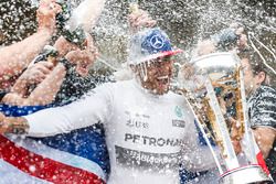 Podium: race winner Lewis Hamilton, Mercedes gets a Champagne soaking from his team after securing a