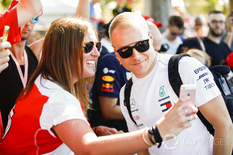 Valtteri Bottas, Mercedes AMG F1, has his photo taken with a fan