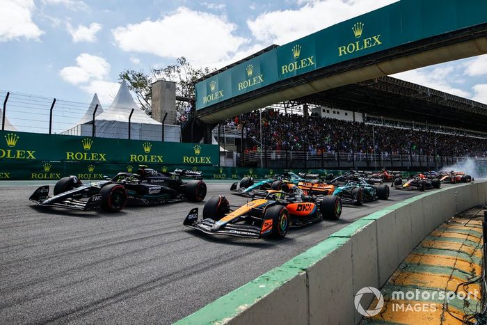 Lando Norris, McLaren MCL60, Lewis Hamilton, Mercedes F1 W14, Fernando Alonso, Aston Martin AMR23, Lance Stroll, Aston Martin AMR23, en la salida mientras Kevin Magnussen, Haas VF-23, Alex Albon, Williams FW45, chocan en segundo plano.