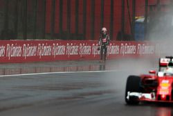 Sebastian Vettel, Ferrari SF16-H passes Romain Grosjean, Haas F1 Team, who crashed on the way to the grid