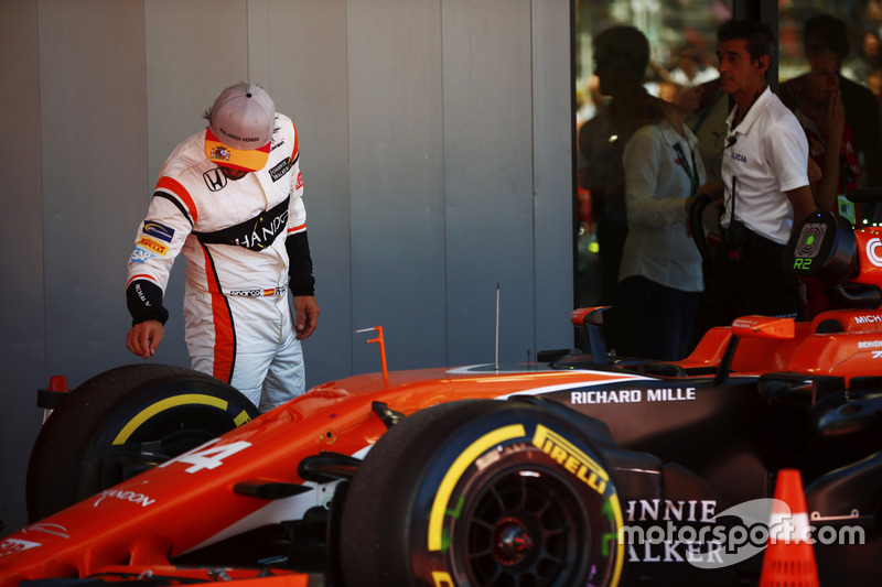 Fernando Alonso, McLaren, inspects his tyres in Parc Ferme