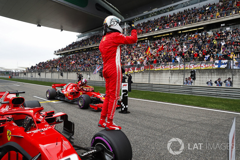 Sebastian Vettel, Ferrari, celebrates pole as team mate and front row starter Kimi Raikkonen, Ferrar