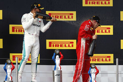 Lewis Hamilton, Mercedes AMG F1, 1st position, sprays Kimi Raikkonen, Ferrari, 3rd position, with Champagne on the podium