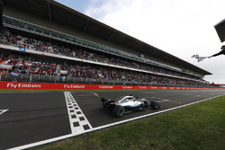 Lewis Hamilton, Mercedes AMG F1 W09, takes the chequered flag at the finish