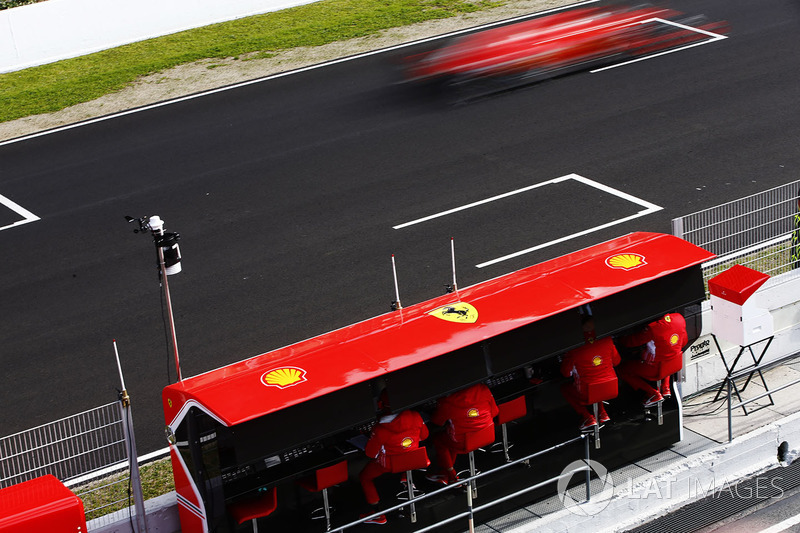 Sebastian Vettel, Ferrari SF71H, flashes past his pit wall gantry