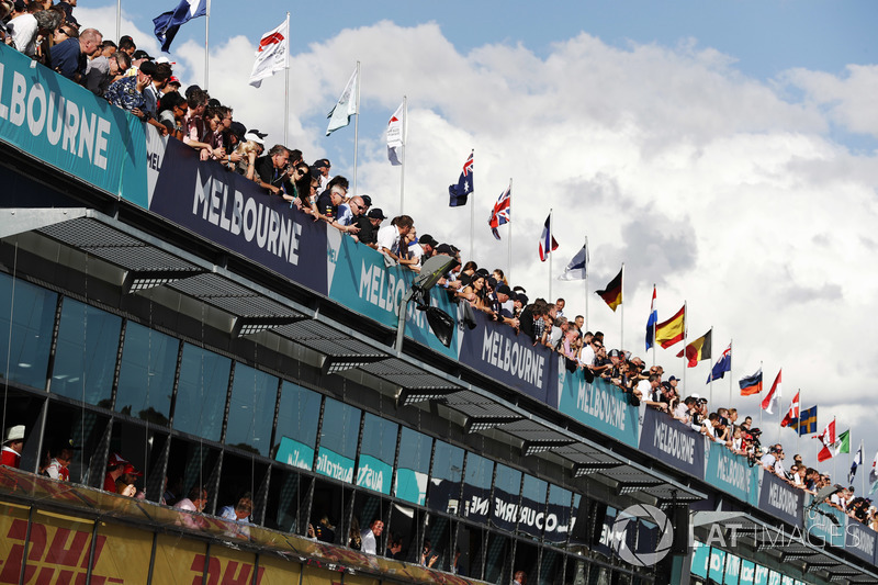 Fans watch action from above the pit lane