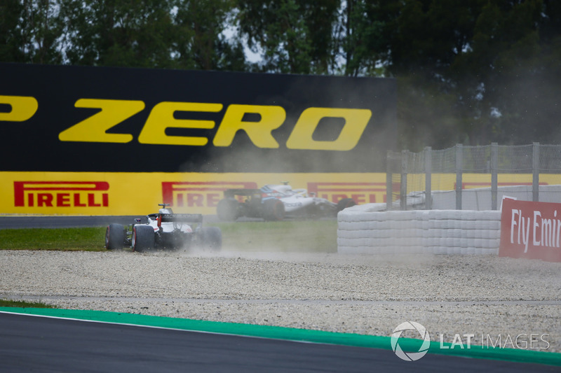 Romain Grosjean, Haas F1 Team VF-18, runs through a gravel trap after a misundrstanding with Sergey Sirotkin, Williams FW41