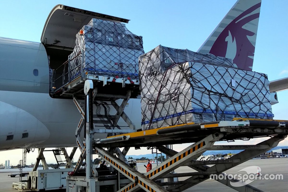 A cargo plane is being prepared to transport motorcycles and equipment for MotoGP teams.