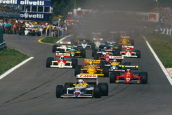 Nigel Mansell, Williams FW11B Honda, leads Gerhard Berger, Ferrari F187, Ayrton Senna, Lotus 99T Hon