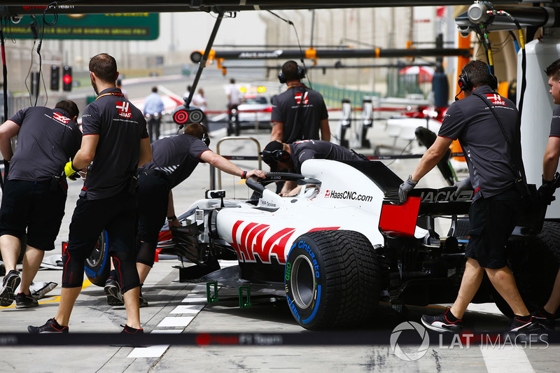 The Romain Grosjean Haas F1 Team VF-18 Ferrari is attended to by mechanics