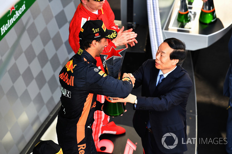 Race winner Daniel Ricciardo, Red Bull Racing celebrates on the podium with the trophy