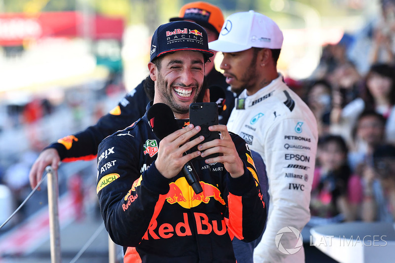 Daniel Ricciardo, Red Bull Racing celebrates with his phone on the podium