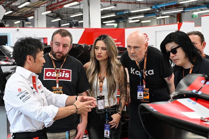 Ayao Komatsu, Team Principal of Haas F1 gives a tour to Smashing Pumpkins in the garage 