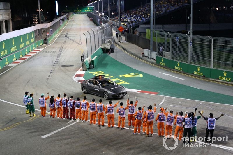 Marshals wave at Race Control Car