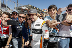 Fernando Alonso, McLaren, has his photo taken with fans