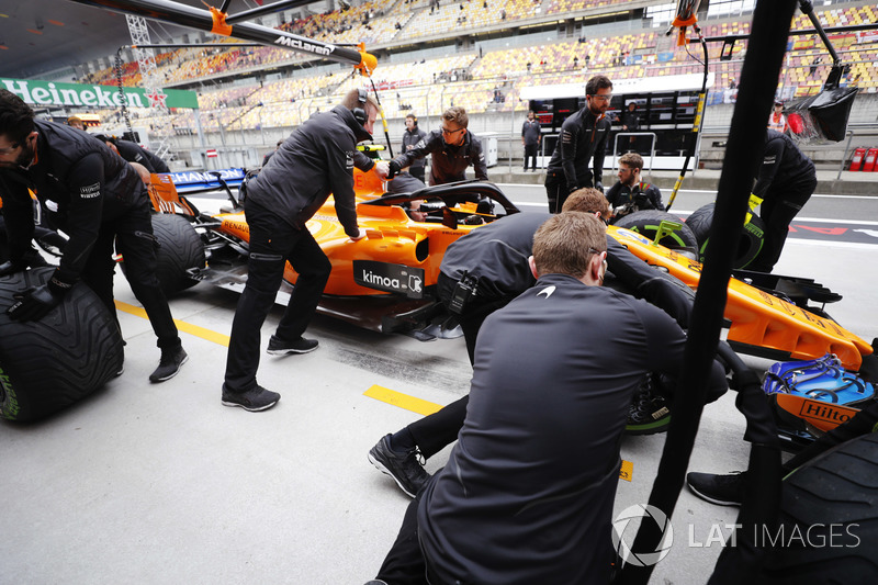 The McLaren team conduct practice pit stops