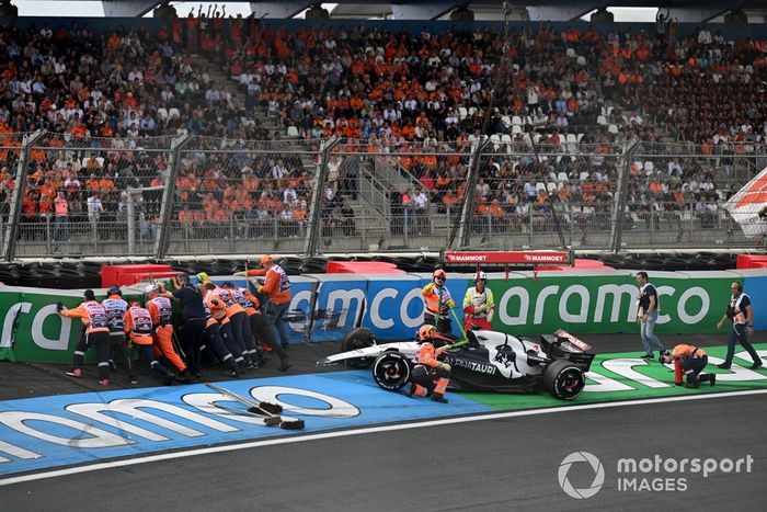 Los comisarios reparan las barreras y se ocupan del coche dañado de Daniel Ricciardo, AlphaTauri AT04