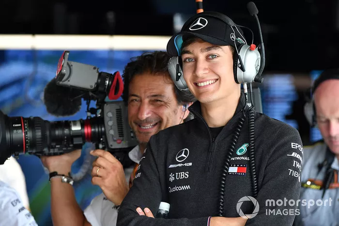 George Russell, Mercedes AMG F1 and Jean-Michel Tibi, FOM Cameraman 