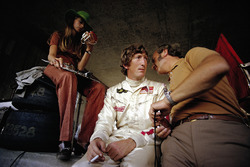 Jochen Rindt dans les stands avec son épouse Nina au chronomètre et Colin Chapman, directeur d'équipe, Lotus