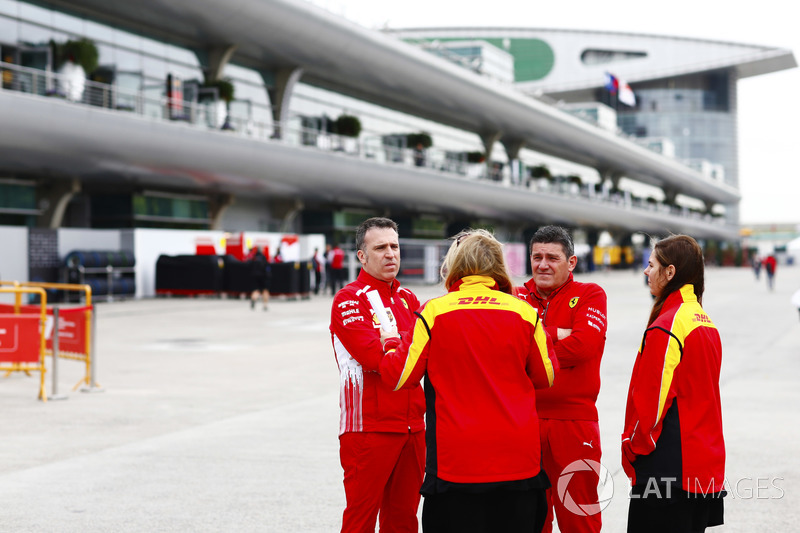 Ferrari and DHL personnel mingle