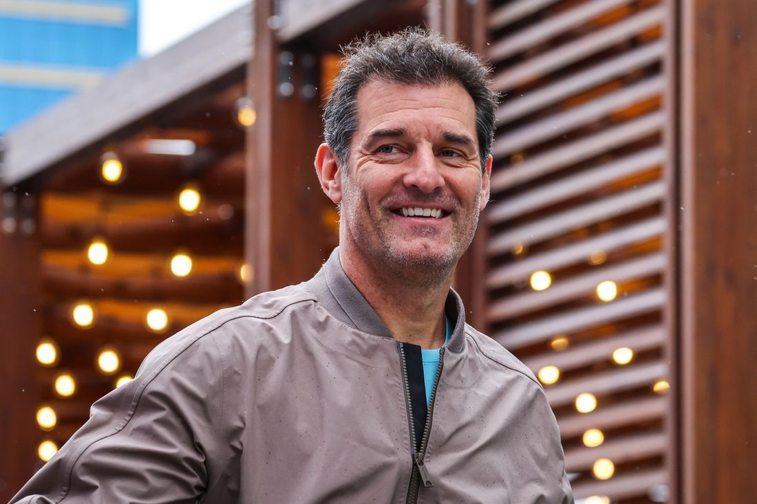 Mark Webber walks in the paddock during final practice