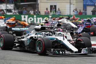 Valtteri Bottas, Mercedes AMG F1 W09, leads Romain Grosjean, Haas F1 Team VF-18