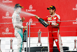 (L to R): Race winner Nico Rosberg, Mercedes AMG F1 celebrates with the champagne on the podium with