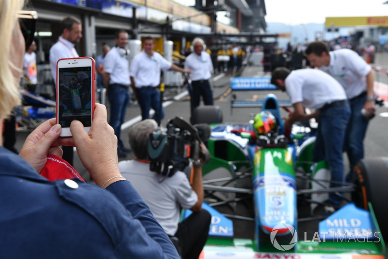 Sabine Kehm, takes a photo of Mick Schumacher, Benetton B194