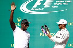 Usain Bolt presents Race winner Lewis Hamilton, Mercedes AMG F1, with a pair of his running shoes