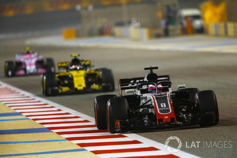 Romain Grosjean, Haas F1 Team VF-18 Ferrari, leads Carlos Sainz Jr., Renault Sport F1 Team R.S. 18