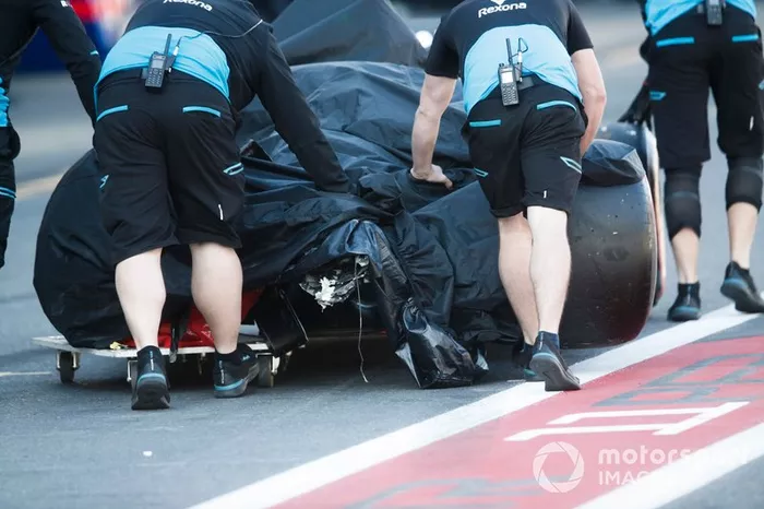 Crashed Car of Robert Kubica, Williams FW42 being pushed by mechanics back to the garage