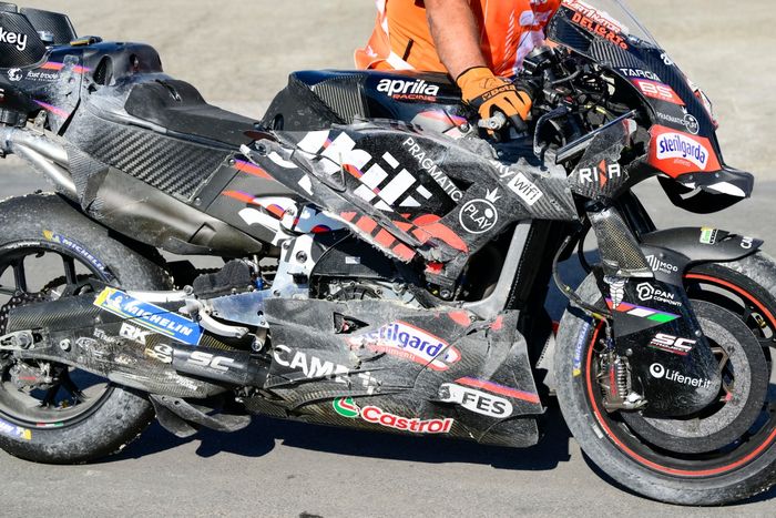 A crashed Factory Racing Aprilia is pushed back to the paddock.