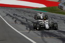 Charles Leclerc, Sauber C37 and Marcus Ericsson, Sauber C37 cross the line