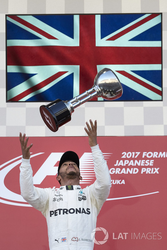 Race winner Lewis Hamilton, Mercedes AMG F1, tosses his trophy in the air in celebration