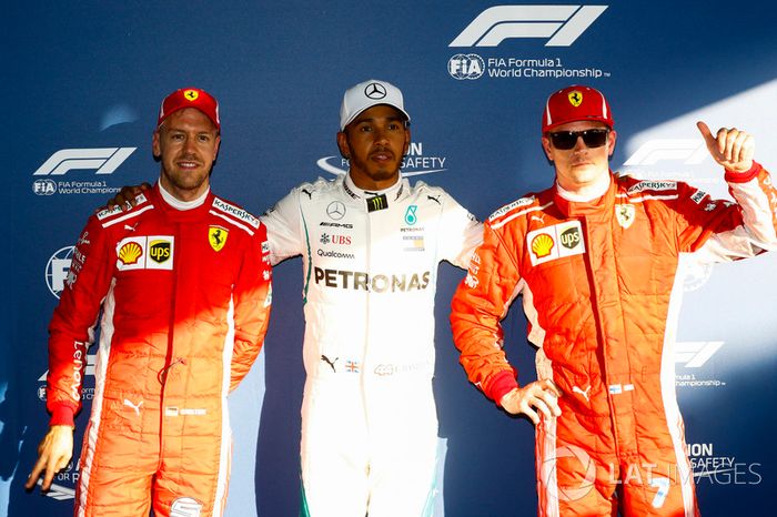 Lewis Hamilton, Mercedes AMG F1, celebrates taking pole position between Kimi Raikkonen, Ferrari, and Sebastian Vettel, Ferrari