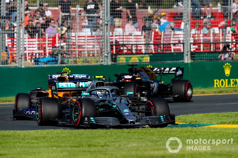 Valtteri Bottas, Mercedes AMG W10, leads Carlos Sainz Jr., McLaren MCL34, and Romain Grosjean, Haas F1 Team VF-19