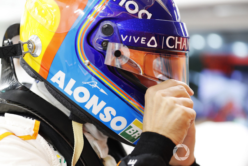 Fernando Alonso, McLaren puts on his helmet in the garag