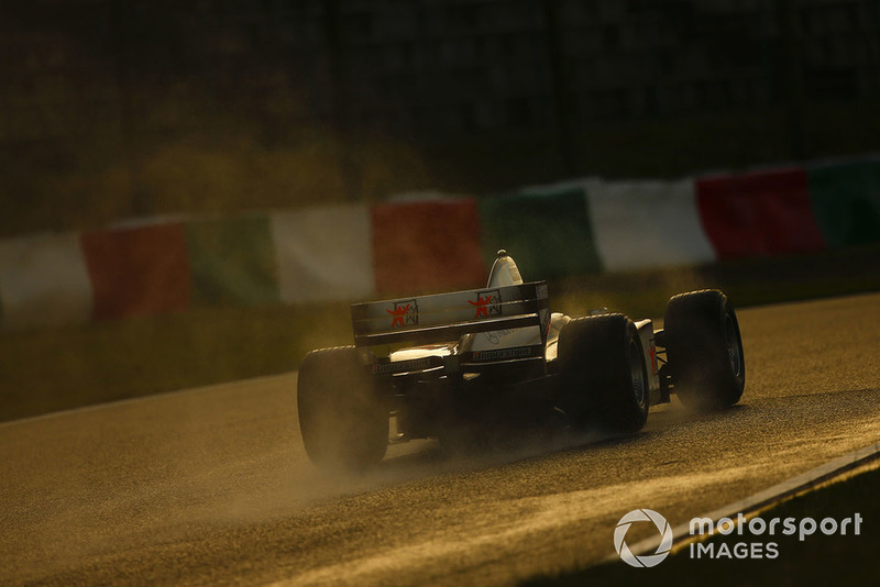 The 1998 McLaren MP4/13 is driven around the circuit