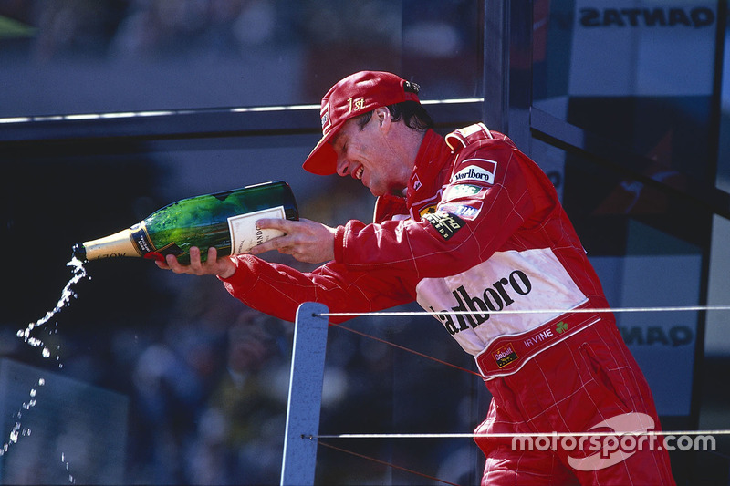 Podium: winner Eddie Irvine, Ferrari celebrates