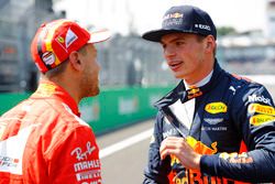 Pole winner Sebastian Vettel, Ferrari, talks to second place Max Verstappen, Red Bull Racing